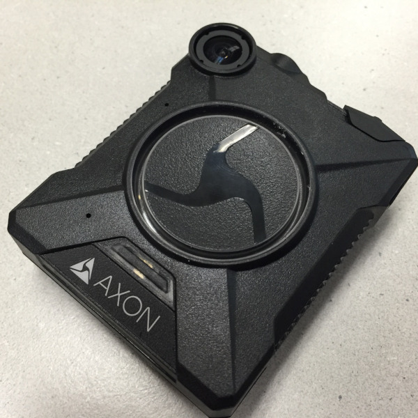 Axon-brand body-worn camera laying on a table