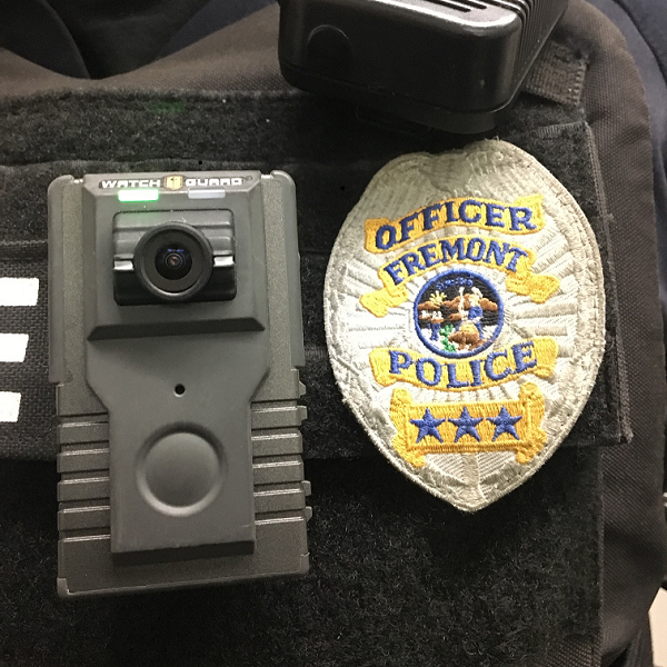 WatchGuard brand body worn camera affixed to an officer's uniform