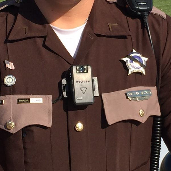Wolfcom brand body worn camera affixed to an officer's uniform
